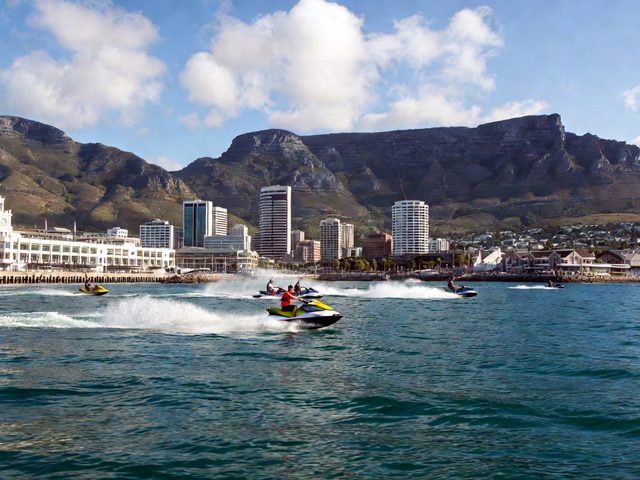 Group of jet skis in front of the V&A Waterfront and Table Mountain